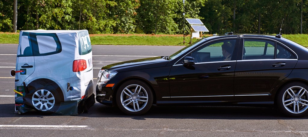 Running into an actual car puts the test driver at risk and is expensive, so IIHS uses a stationary target as a stand-in. Under the vinyl cover, inflatable tubes and foam sit on a metal frame, which is then affixed to metal guides on the track to keep the target from moving until it is struck by the test vehicle. A GPS system and other sensors monitor the test vehicle's lane position, speed, time to collision, braking and other data. An onboard camera captures each test run from the driver's perspective and monitors any warnings issued by the front crash prevention system.